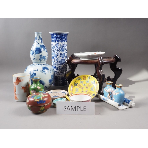 50 - A large selection of Chinese ceramics, wood stands, etc