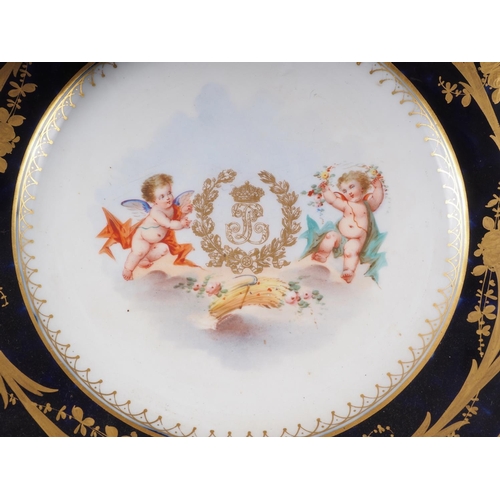 8 - Six Sevres plates with central putti decoration and blue and gilt decorated borders, 9 1/2