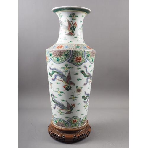 35 - A Chinese famille vert vase with flared rim and tapering body, decorated phoenix and clouds, on hard... 