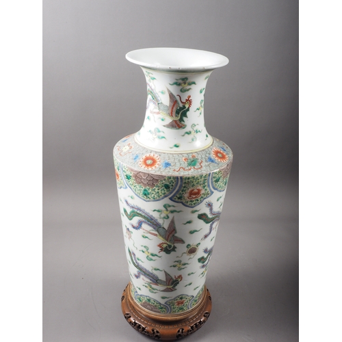 35 - A Chinese famille vert vase with flared rim and tapering body, decorated phoenix and clouds, on hard... 