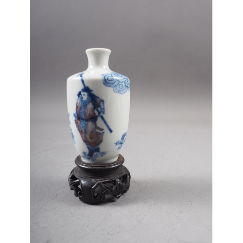 43 - A Chinese blue and white and iron red porcelain miniature vase, decorated single figure, four-charac... 