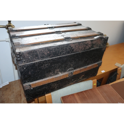 438 - A tin and wooden bound travel trunk, 25