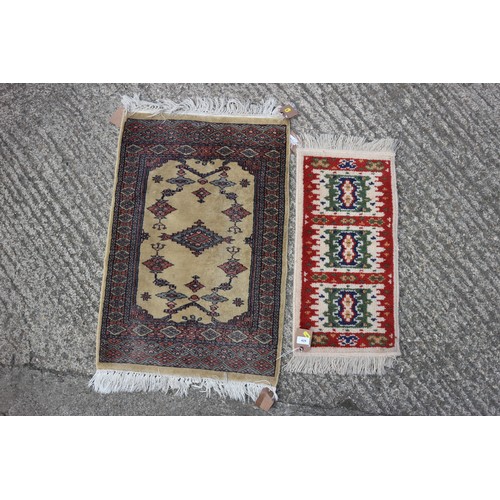 429 - A prayer mat, decorated in shades of red and natural, 33