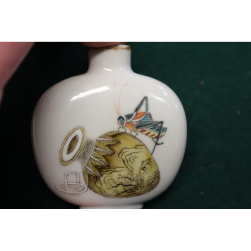 40 - A Chinese porcelain snuff bottle, decorated crickets, seal mark to base, on wooden stand, 2 1/4