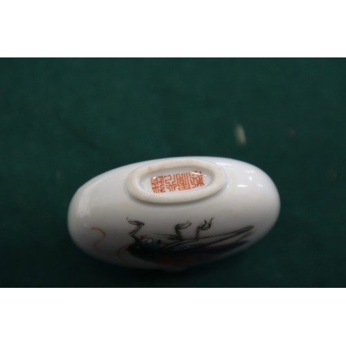 40 - A Chinese porcelain snuff bottle, decorated crickets, seal mark to base, on wooden stand, 2 1/4