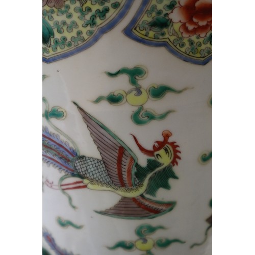 35 - A Chinese famille vert vase with flared rim and tapering body, decorated phoenix and clouds, on hard... 