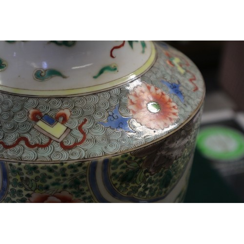 35 - A Chinese famille vert vase with flared rim and tapering body, decorated phoenix and clouds, on hard... 