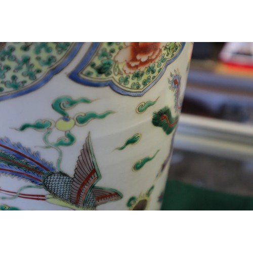 35 - A Chinese famille vert vase with flared rim and tapering body, decorated phoenix and clouds, on hard... 