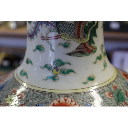 35 - A Chinese famille vert vase with flared rim and tapering body, decorated phoenix and clouds, on hard... 