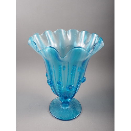 27 - A blue glass pedestal vase with shaped flared rim and applied decoration, 14 1/2