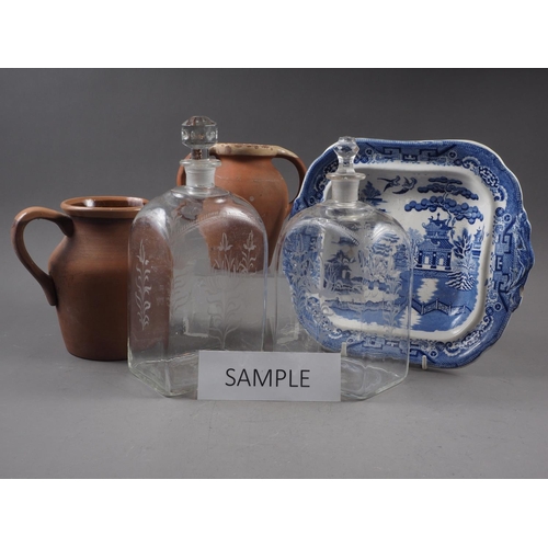 76 - Two clear glass Dutch decanters with matched stoppers, five terracotta jugs and other items