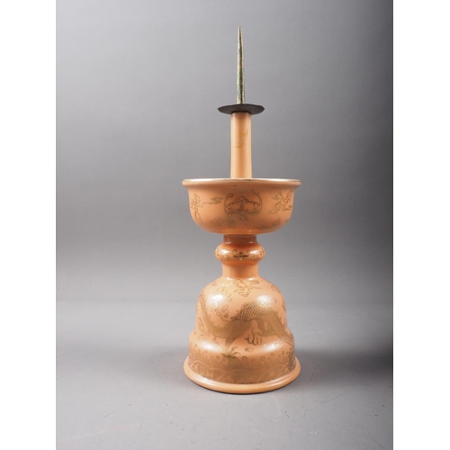 131 - A Chinese peach glazed pricket candlestick with gilt dragon and wave decoration, 11 1/2