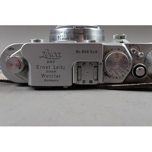 162 - A Leica DRP rangefinder camera, No 666946, with Sumar 50mm f1.2 lens, No 315659, and hand grip