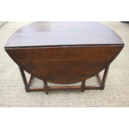 508 - A 19th century oak drop leaf dining table, on bobbin turned and stretchered supports, 50