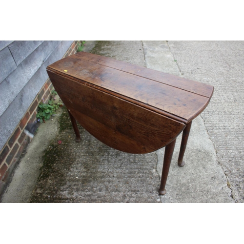 517 - An 18th century provincial oak oval drop leaf table, on turned supports and pad feet, 43