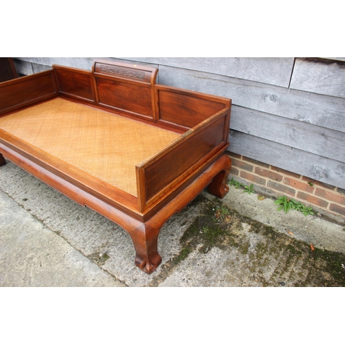 520 - A Chinese hardwood (huanghuali) bed, with woven bamboo seat, on scroll supports, 77