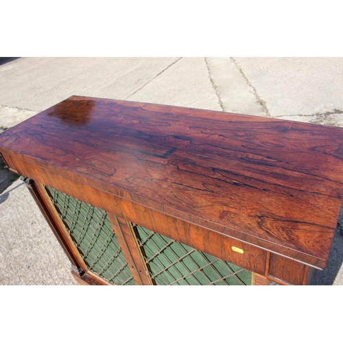 523 - A Regency rosewood chiffonier, fitted frieze drawer over two brass lattice panel doors, on block bas... 