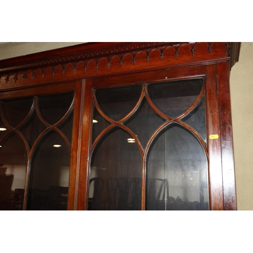 539 - A 19th century mahogany bookcase, the upper section enclosed Gothic lattice glazed doors, over two d... 