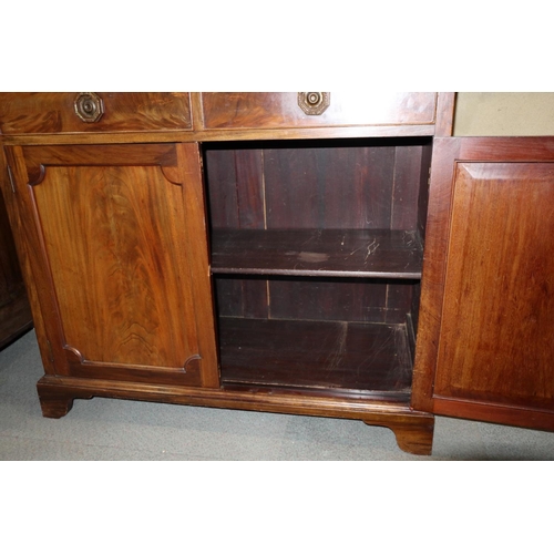 539 - A 19th century mahogany bookcase, the upper section enclosed Gothic lattice glazed doors, over two d... 