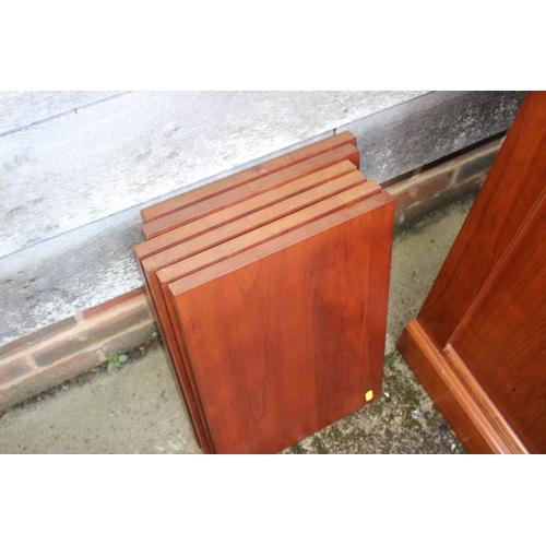 597 - A cherrywood side cabinet, fitted two glazed compartments, central recess over three drawers and thr... 