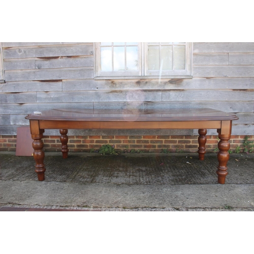 598 - A cherrywood dining table, on turned supports, 88