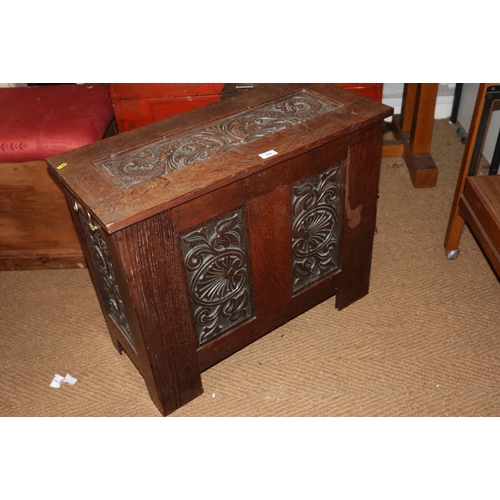 643 - An early 20th century scroll carved coffer with brass carry handles, on stile supports, 30