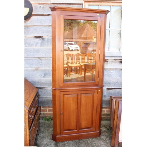 597 - A cherrywood side cabinet, fitted two glazed compartments, central recess over three drawers and thr... 