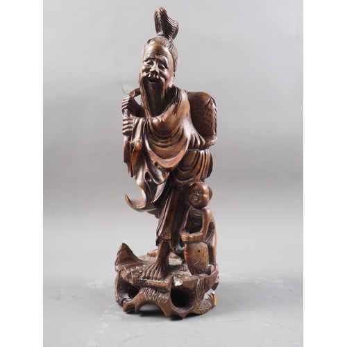 139 - A Chinese carved hardwood figure of a sage and acolyte, 12