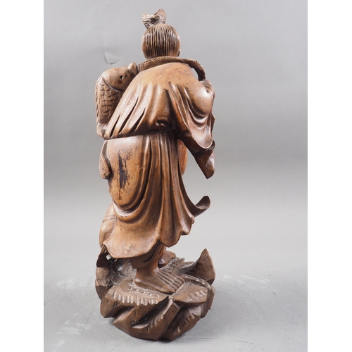 139 - A Chinese carved hardwood figure of a sage and acolyte, 12