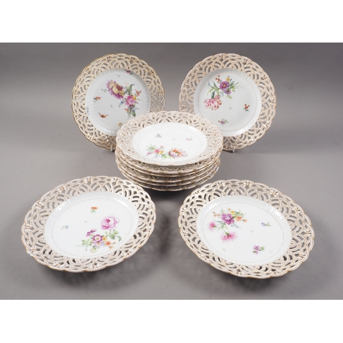 16 - Ten KPM porcelain plates with reticulated and gilded borders and hand painted floral centres, 9