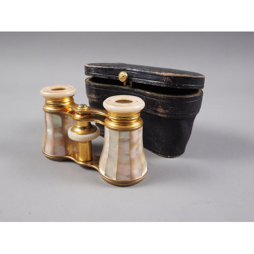 277 - A pair of gilt brass and mother-of-pearl opera glasses, by Ferguson & Weston, in fitted leather ... 