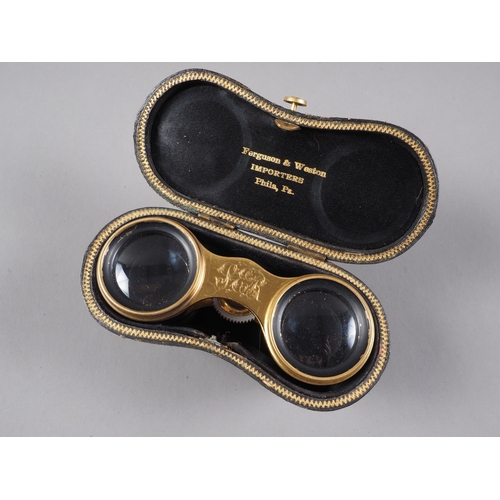 277 - A pair of gilt brass and mother-of-pearl opera glasses, by Ferguson & Weston, in fitted leather ... 