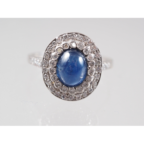 366 - A white metal, sapphire cabochon and diamond set cluster ring, size S natural fault