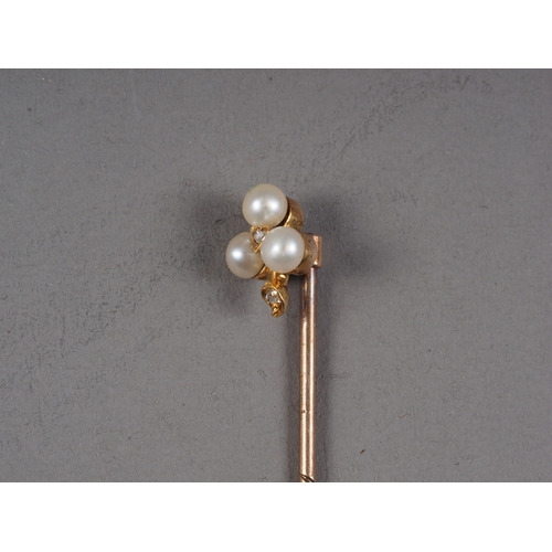 383 - A yellow metal, seed pearl and diamond stick pin