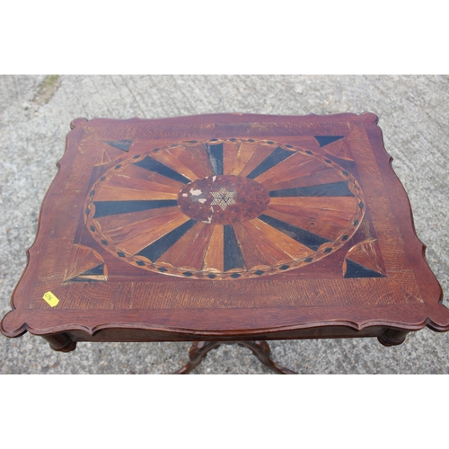 488 - A late 19th century carved walnut and parquetry shape top work table with part fitted interior, on t... 