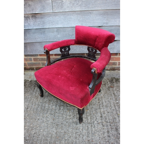 491 - A Victorian chair with ebonised splat back, upholstered in a red velour, on cabriole supports