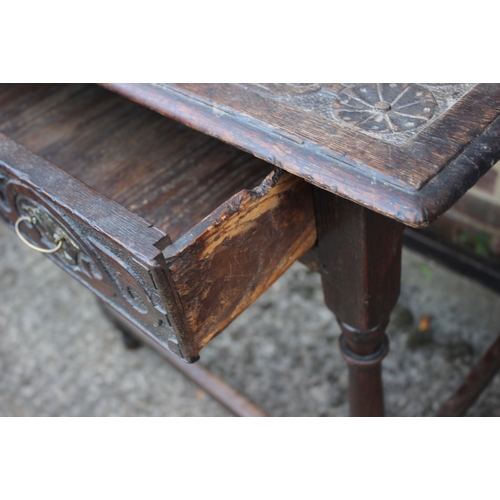 493 - An 18th century provincial carved oak side table, fitted one drawer, on turned and stretchered suppo... 