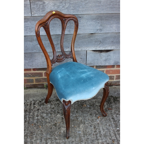 498 - A 19th century carved mahogany shape back side chair and a child's deportment/high chair