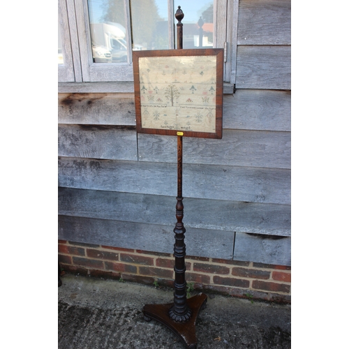 500 - An early 19th century pole screen with rosewood framed sampler panel, worked by Lucy Pridgeon 1809