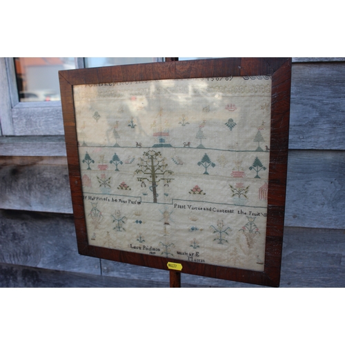 500 - An early 19th century pole screen with rosewood framed sampler panel, worked by Lucy Pridgeon 1809