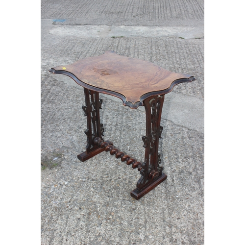 501 - A late Victorian figured walnut shape top occasional table, on carved panel end supports, united by ... 