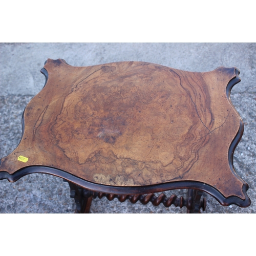 501 - A late Victorian figured walnut shape top occasional table, on carved panel end supports, united by ... 