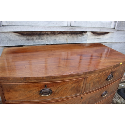 516 - An early 19th century mahogany bowfront chest of two short and three long graduated drawers with sta... 