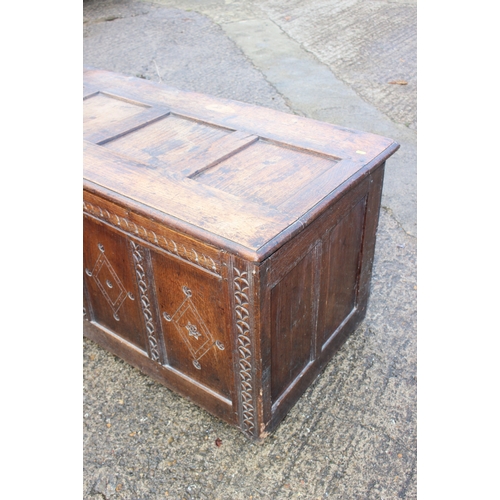 529 - An 18th century chip carved oak triple panel coffer, with candle box, 57