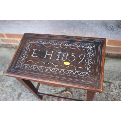 533 - A 19th century carved oak stool/occasional table, on square taper supports, inscribed EH 1859, 17