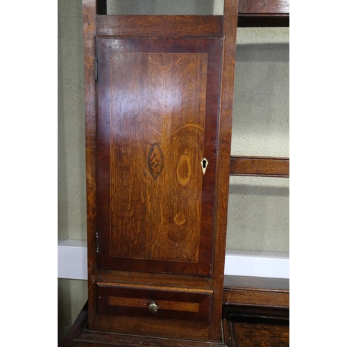 540 - An early 19th century oak and mahogany banded dresser, the upper section fitted open shelves with fl... 