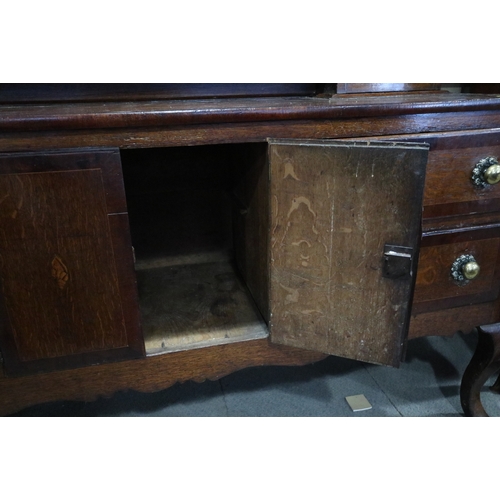 540 - An early 19th century oak and mahogany banded dresser, the upper section fitted open shelves with fl... 