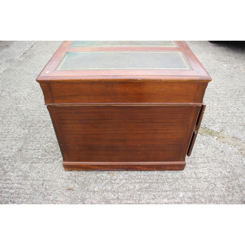 591 - A partners figured mahogany double pedestal desk with triple panel tooled leather top over nine draw... 