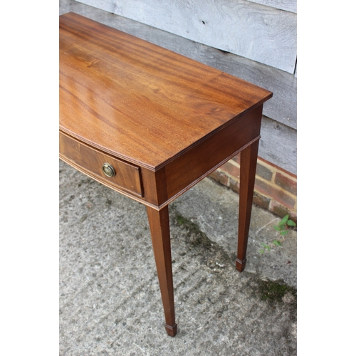 603 - A bowfront side table, fitted three drawers, on square taper supports, 36