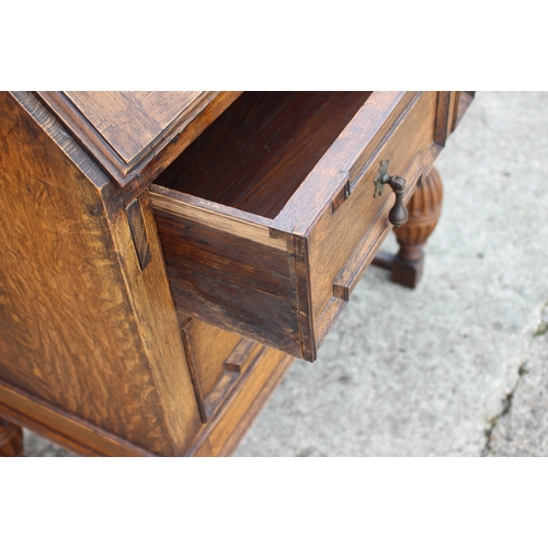 606 - An oak fall front bureau with fitted interior over two long drawers, on turned and stretchered suppo... 